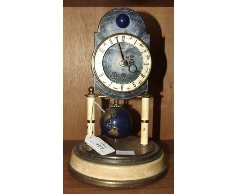 A Kaiser Clock Company '400-day' timepiece, the celestial blue dial depicting the Solar System, beneath a rolling moon to the