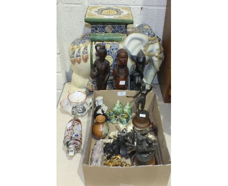 An Oriental ceramic garden stool in the form of an elephant, 39cm high, three carved wood tribal figures, a pair of metal Asi