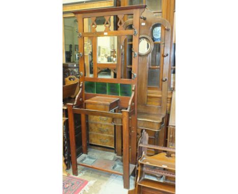 An Edwardian stained mahogany hall stand with central square mirror above tiled back, glove box and twin stick stand, 74cm wi