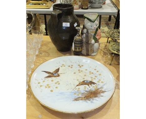 A ceramic circular wall plaque decorated with wading birds and foliage, 39cm diameter, a two-handled brown-glazed pottery vas