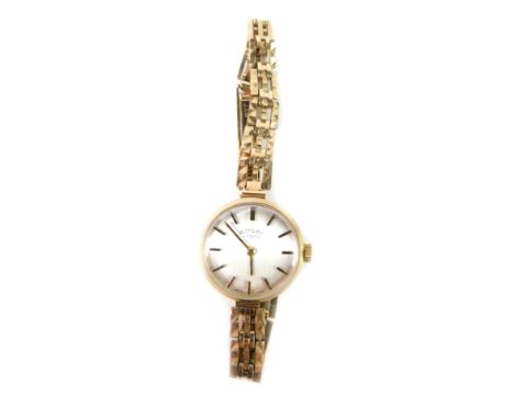 A Rotary lady's 9ct gold cased wristwatch, silvered dial with gilt batons, on a 9ct gold bracelet, 15.4g all in.