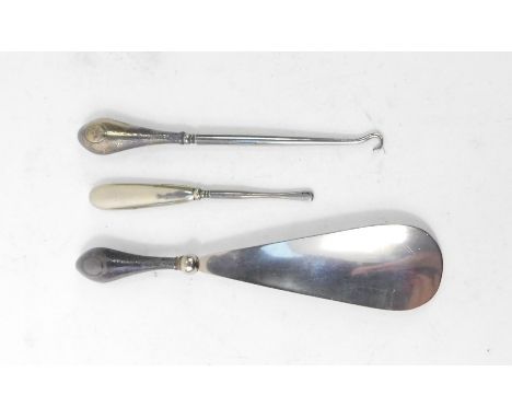 A George V steel shoehorn and button hook, with silver handles, Birmingham 1920, and a manicure implement with a silver plate