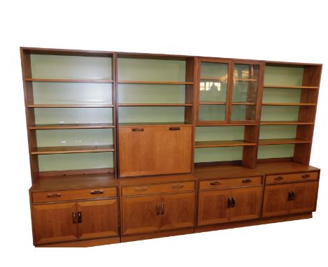 A G-Plan 1960's four section lounge unit, comprising a pair of bookcases, each with four shelves over a single frieze drawer 