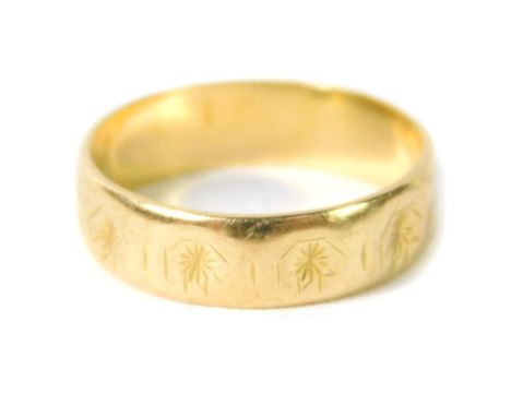 An 18ct gold wedding band, with faceted and engraved decoration, size K, 3.0g.