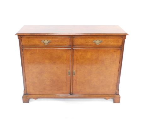 A Georgian style burr yew wood and mahogany cross banded side cabinet, with herringbone inlay, having two drawers above cupbo