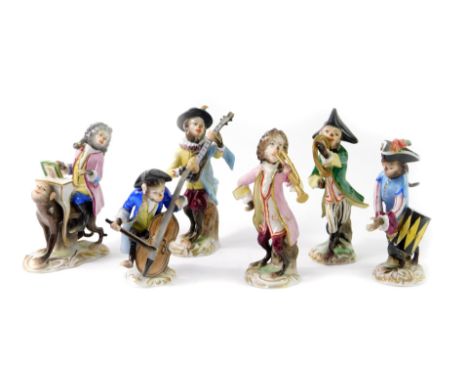 A set of six Volkstedt 20thC porcelain monkey band figures, comprising conductor, French horn, mandolin and trumpet players, 