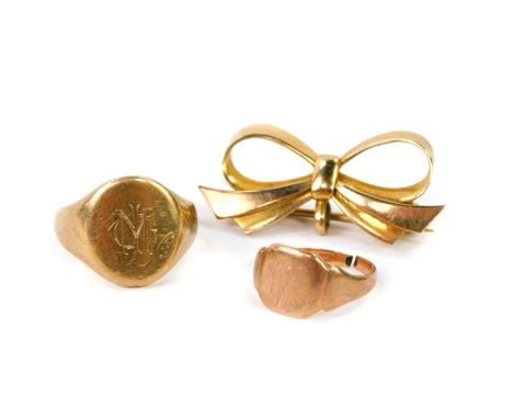 A 9ct gold bow brooch, 3.3g, a 9ct gold signet ring, initialled engraved, size K, 4.8g, and a child's 9ct gold signet ring, 1