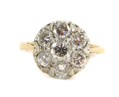 An 18ct gold and diamond daisy ring, set with seven brilliant cut diamonds, approx 1.1cts, size M, 3.7g.