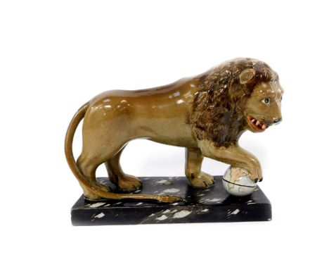 A Ralph Wood Staffordshire late 18thC pottery figure of The Medici Lion, modelled standing with his paw on a globe, raised on