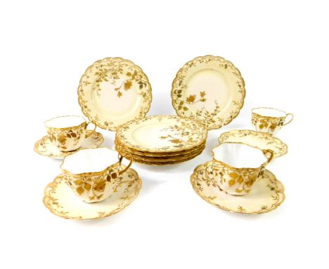 A Limoges late 19thC porcelain part tea service, of spiral fluted form, gilt decorated with blossom and trailing leaves, comp