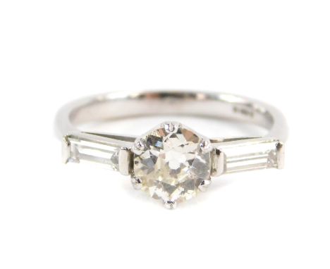 An 18ct white gold three stone diamond ring, with a central round brilliant cut diamond approx 0.83cts, in a six claw setting