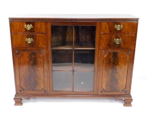 A Georgian style mahogany bookcase, with a glazed central door enclosing three shelves, flanked by four drawers above cupboar