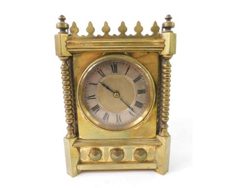 A Victorian Gothic brass mantel clock, circular dial with silver chapter ring, bearing Roman numerals, clockwork thirty hour 