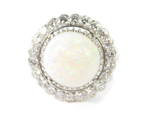 An 18ct gold opal and diamond ring, the cabachon opal approx 5ct, in a surround of 22 brilliant cut diamonds, approx 1.4ct, s