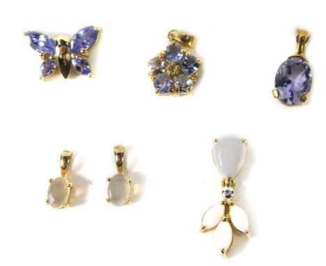 Six 9ct gold and gem set pendants, including two jelly opal pendants, tanzanite and diamond flower head pendant, and a multi 