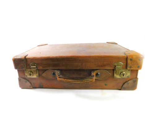 A vintage tan leather suitcase, with brass lock plates, 63cm W, 37cm D.