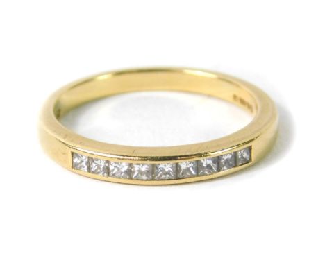 An 18ct gold and diamond half hoop eternity ring, channel set with nine princess cut diamonds, size N, 3.3g.