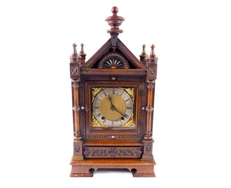 A Victorian oak cased mantel clock, square brass dial with gilt floral spandrels, silvered chapter ring bearing Roman numeral