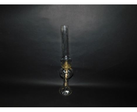 A Victorian moulded clear glass oil lamp, raised on spiral fluted stem, with chimney, 53cm H.
