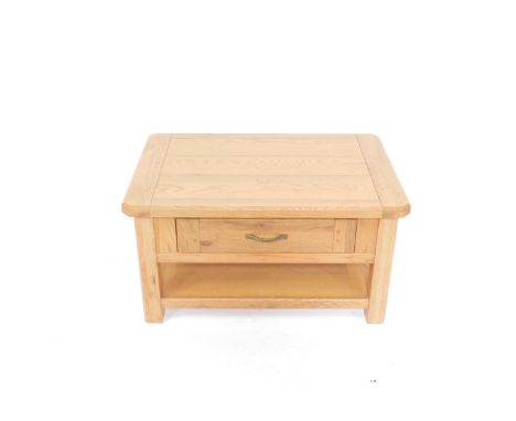 A light oak occasional table, the canted rectangular plank top, over a single frieze drawer, raised on square legs, united by