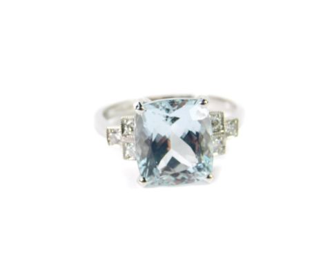 An 18ct white gold aquamarine and diamond ring, of high claw set stepped form, with rectangular cushion shaped aquamarine and