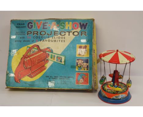Chad Valley Give-a-Show projector, boxed; German tinplate fairground ride. (2)
