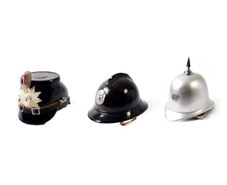 A German Police Shako, with black patent finish, white metal helmet plate for Berlin surmounted by white metal and red enamel