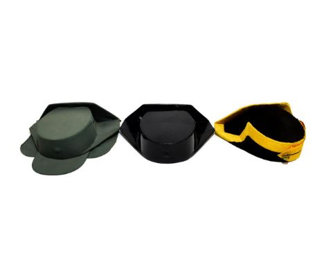 A Ceremonial Spanish Guardia Civil Tricornio, in black plush with yellow braid trim, red and yellow cockade and brass button;