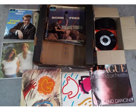 A collection of 12" and 7" vinyl records to include The Human League, Status Quo, The Rolling Stones, The Jam and other.