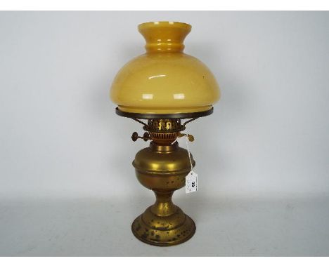 A vintage brass oil lamp with glass shade, approximately 41 cm (h).