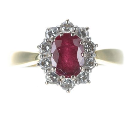 Good modern 18ct yellow gold ruby and diamond oval cluster ring, the oval ruby 1.00ct approx, set in a border of ten round br