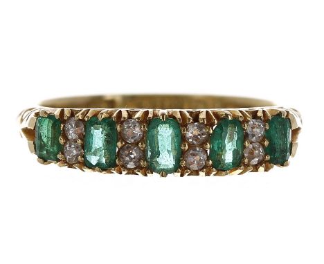 Edwardian 18ct claw set emerald and diamond ring, Birmingham 1901, with five oval emeralds, 0.50ct approx in total, eight sma