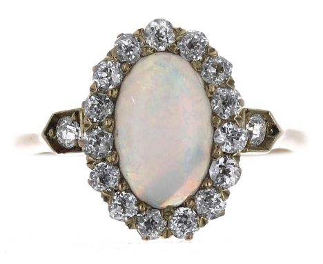 Pretty 18ct cabouchon opal and diamond oval cluster ring, the opal 1.00ct approx, in a border of round diamonds, 0.50ct appro