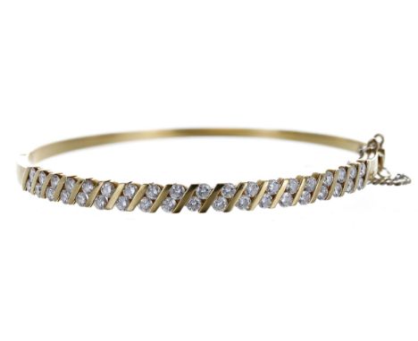 Diamond set yellow gold hinged bangle, round brilliant-cuts, 1.15ct approx in total, with safety chain, 12.6gm, width 4mm 