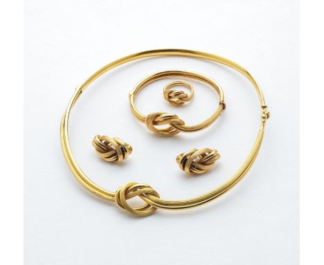 KNOT BRACELET, ILIAS LALAOUNIS, 1970s a hinged bangle formed as a double strand overhand knot, one strand reeded, the other p