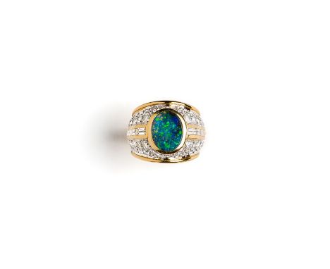 DIAMOND AND OPAL DRESS RING the oval cabochon opal set between a row of channel set baguette diamonds in a bezel pavé set wit