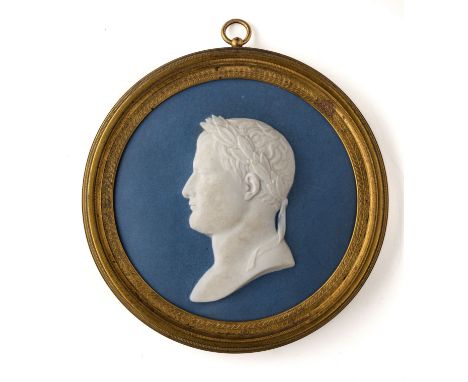 A SEVRES BISCUIT PORTRAIT MEDALLION OF NAPOLEON I, EMPEROR OF THE FRENCH, CIRCA 1809 after the model by Bertrand Andrieu, the