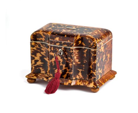 ˜A BLOND TORTOISESHELL TEA CADDY, ENGLISH, CIRCA 1830 arc-en-arbelette fronted, domed lid, spreading plinth base on bun feet,