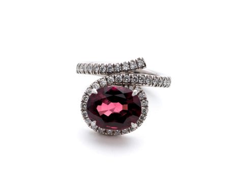 RED SPINEL, DIAMOND AND PLATINUM DRESS RING, BOODLE &amp; DUNTHORNE the oval spinel of 7.39 carats, the bezel continuing roun