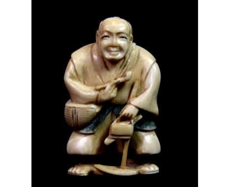 A 19th century Japanese carved ivory netsuke of a gentleman holding a pipe, H. 6.5cm.