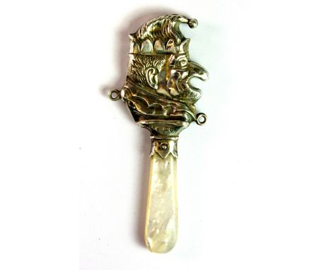 A hallmarked silver and mother of pearl childs teether in the form of Mr. Punch, William Henry Christie, Chester c. 1959, L. 