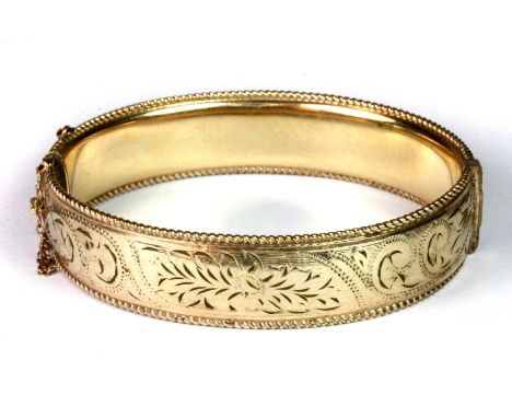 A 9ct yellow gold 1/10th metal core bangle , L. 7cm (approx. 27.9gr).