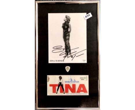 A framed signed photograph of Tina Turner, with a July 2000 ticket, program and t-shirt.