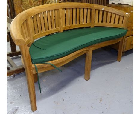 A hardwood banana bench with cushion 