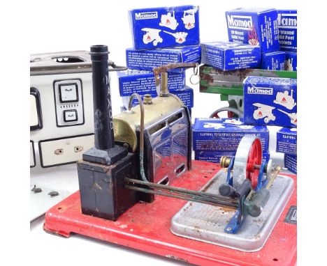 A Mamod painted tinplate stationary engine, a tinplate traction engine cart, Vintage German MFZ tinplate range cooker, and a 