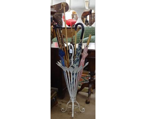 A cream painted metal stick stand, and a quantity of umbrellas, parasols and sticks 