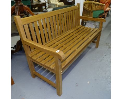 A teak slatted garden bench 