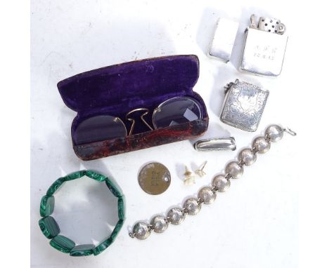 A silver coin set bracelet, Vesta, lighter, marcasite brooches etc 