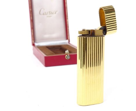 A Cartier gold plated cigarette lighter, model no. D55902, length 7cm, boxed 
