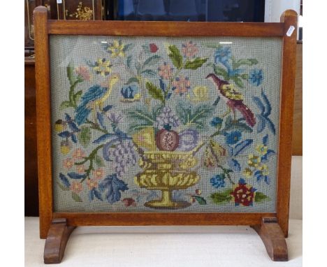 A 1920s oak-framed fire screen with needlework panel 